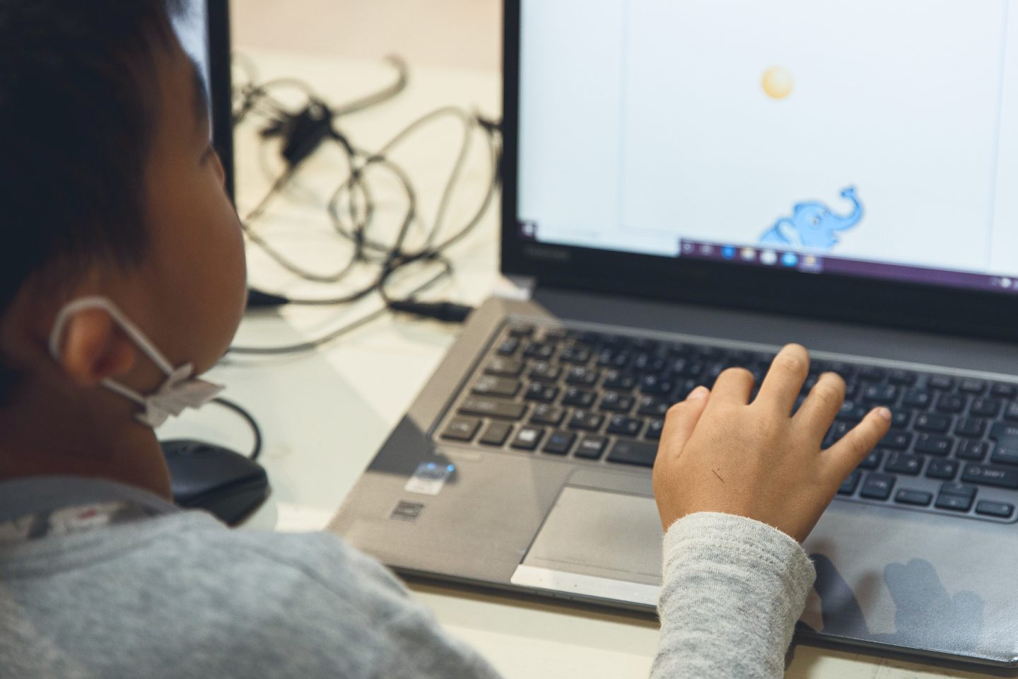 child playing a educational game on a laptop
