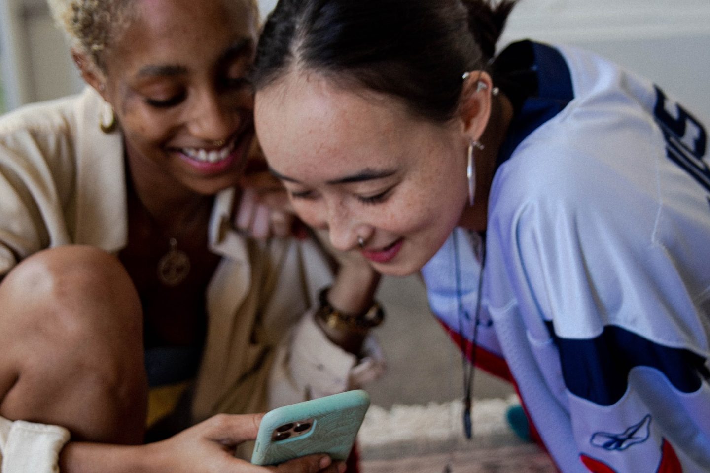 two women looking at a phone