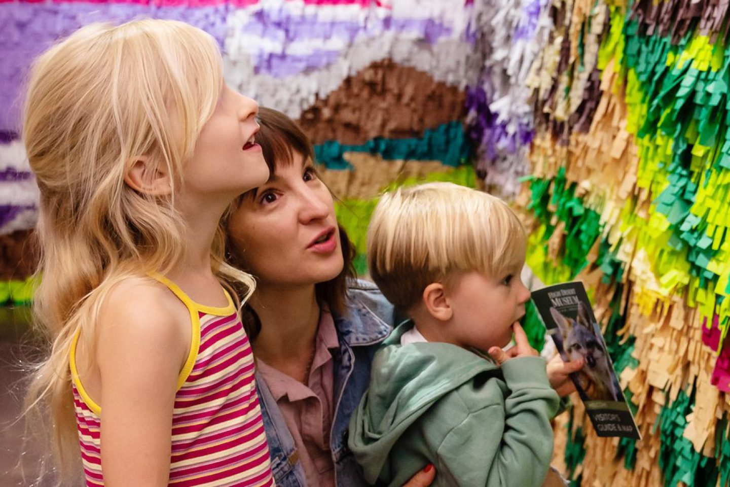 woman and two children admiring walled art project
