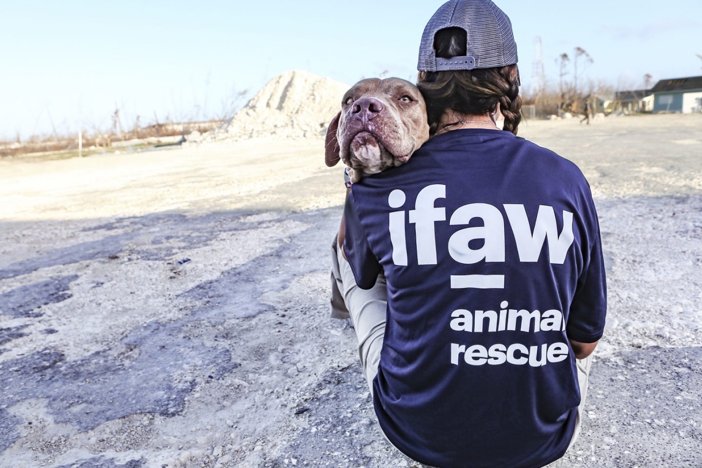IFAW staff woman holding a rescue dog