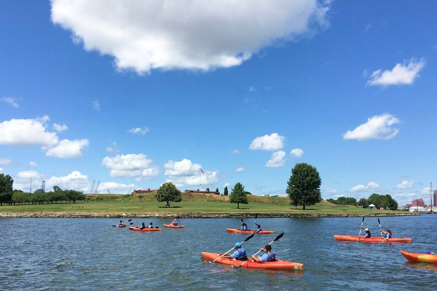 kayakers paddling on a calm lake
