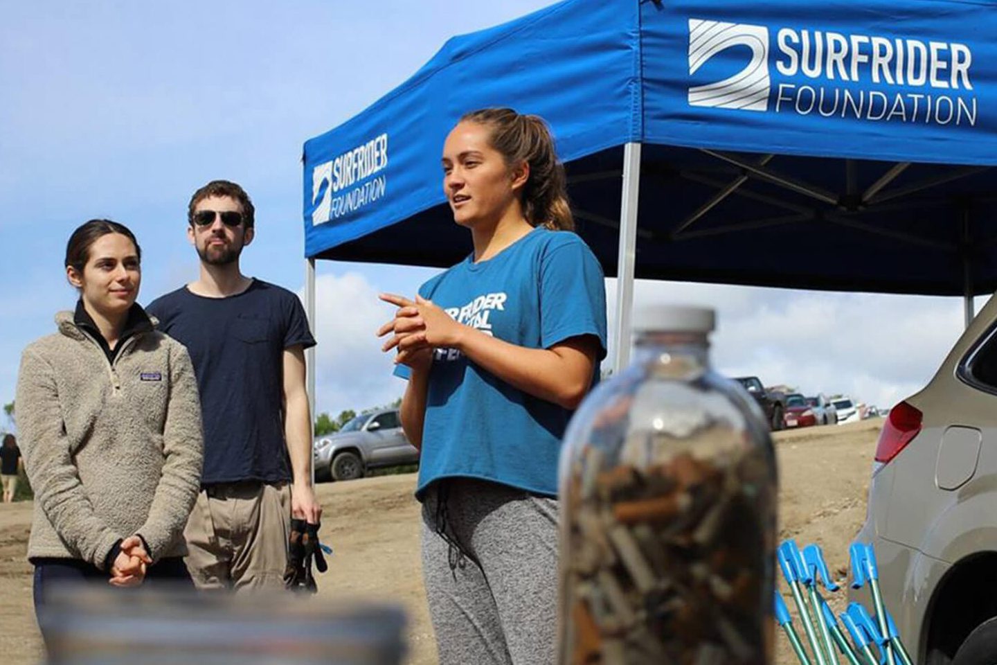 female volunteer at a Surfrider Foundation event at a beach