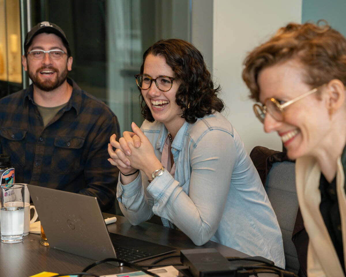 Kelsey, Elizabeth laugh during a meeting