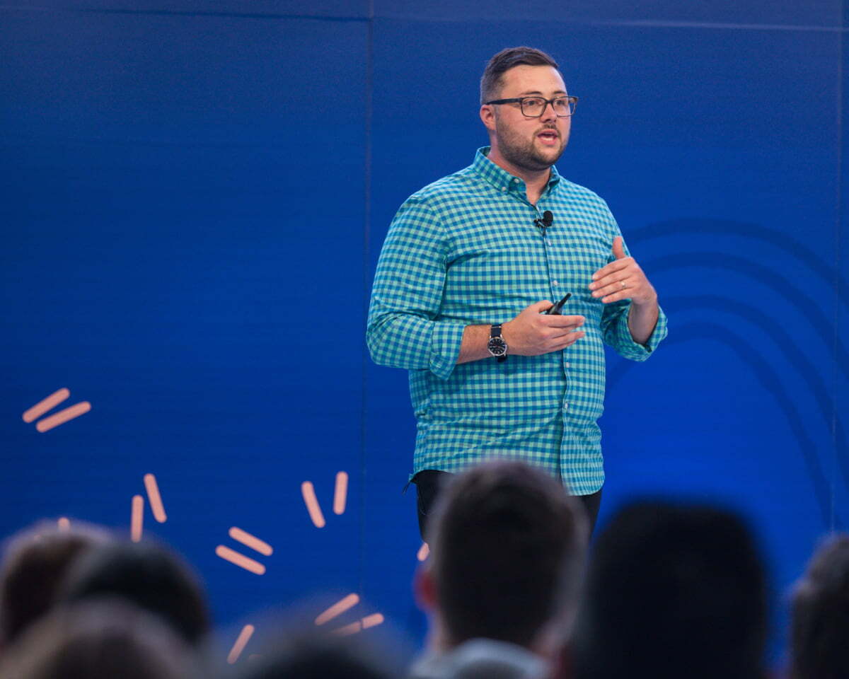 Matt speaking on stage at a conference