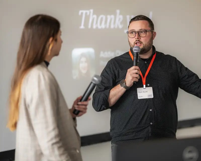 Matt Scott talks to another speaker on stage