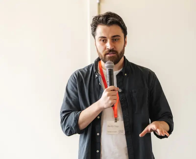A man holding a microphone gives a speech