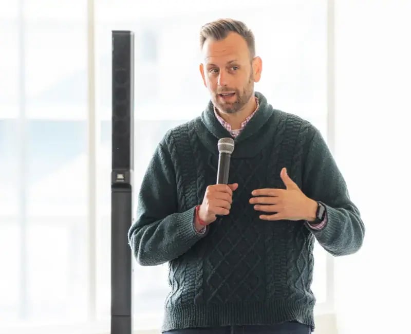 A man giving a presentation holding a microphone