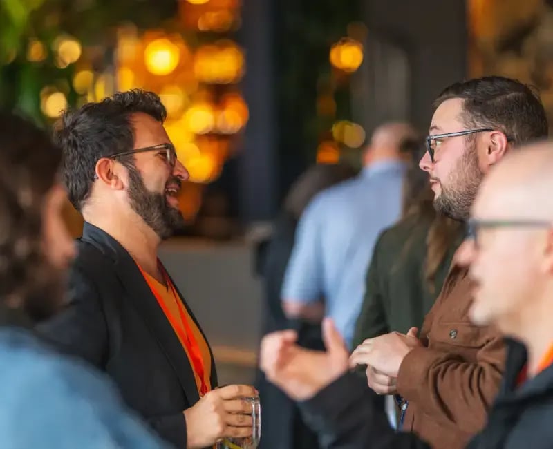 Two men deep in conversation at a bar