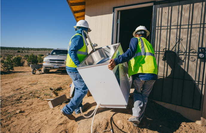 Men installing a new sink in a Navajo home