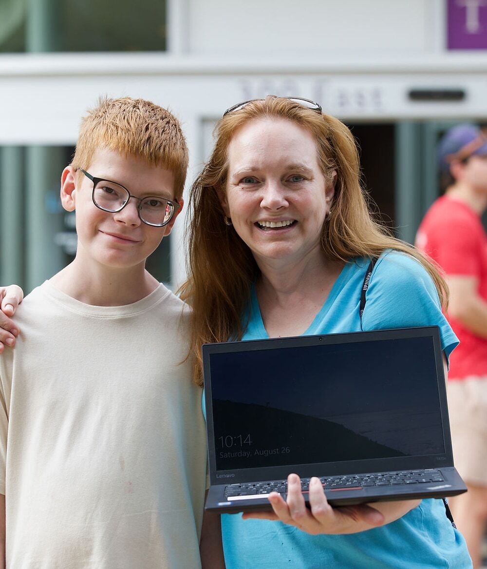 A mother and son posing for a photo