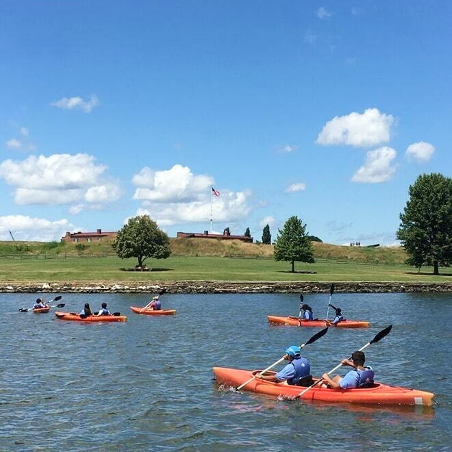 A group of kayakers on the water in Baltimore A group of kayakers on the water in Baltimore